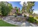 Stone patio featuring a round table with chairs, complemented by an umbrella and privacy screen with decorative metalwork at 6728 S Catawba Way, Aurora, CO 80016