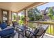 Covered patio with comfortable seating, stone pillars, and scenic views of the landscaped backyard at 6728 S Catawba Way, Aurora, CO 80016