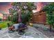 Inviting patio with outdoor seating, a decorative screen, and ambient lighting, set against a backdrop of lush greenery at 6728 S Catawba Way, Aurora, CO 80016