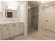 Bright bathroom with modern vanity, glass enclosed shower, and white marbled tile at 98 Glenmoor Ln, Cherry Hills Village, CO 80113