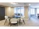 Dining area featuring a round table and chairs, adjacent to an open seating area and plentiful natural light at 98 Glenmoor Ln, Cherry Hills Village, CO 80113