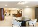 Dining area featuring a round table and chairs, adjacent to an open seating area and bar at 98 Glenmoor Ln, Cherry Hills Village, CO 80113