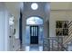 Welcoming foyer with a decorative front door, transom window, and elegant lighting at 98 Glenmoor Ln, Cherry Hills Village, CO 80113