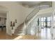 Bright foyer featuring a winding staircase with unique railings, hardwood floors, and an open floor plan at 98 Glenmoor Ln, Cherry Hills Village, CO 80113