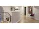 Light-filled hallway with hardwood floors and modern wall art at 98 Glenmoor Ln, Cherry Hills Village, CO 80113