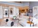 Spacious living area with white sofas, large windows, and an open view to the kitchen and front entrance at 98 Glenmoor Ln, Cherry Hills Village, CO 80113