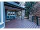 Outdoor porch features stone pillars, wooden deck, seating, and a view at 98 Glenmoor Ln, Cherry Hills Village, CO 80113