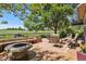 Outdoor patio with a cozy fire pit, beautiful seating, and lush greenery at 7311 Brixham Cir, Castle Pines, CO 80108