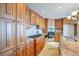 Well-lit kitchen featuring granite countertops, wood cabinets, and stainless steel appliances at 7311 Brixham Cir, Castle Pines, CO 80108