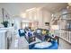 Spacious living room flows into dining area, featuring skylight, and fireplace at 7311 Brixham Cir, Castle Pines, CO 80108