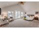 Spacious main bedroom with vaulted ceiling, ceiling fan, access to a balcony, and carpet flooring at 7311 Brixham Cir, Castle Pines, CO 80108