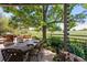 Covered patio featuring an outdoor dining area with golf course views at 7311 Brixham Cir, Castle Pines, CO 80108