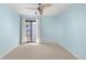 Bright bedroom with light blue walls, carpeting, and sliding door to balcony at 8600 E Alameda Ave # 22-207, Denver, CO 80247