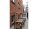 Outdoor patio featuring dining table, chairs, and brick building at 1421 N Pearl St # 2, Denver, CO 80203