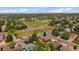 Expansive aerial view of a suburban neighborhood with lush green spaces and a nearby park at 10859 W Fair Ave, Littleton, CO 80127