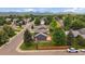 Bird's-eye view of home highlighting the backyard deck, mature trees, and street appeal with mountain views at 10859 W Fair Ave, Littleton, CO 80127