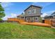 Expansive backyard with deck, shed, and large green space for outdoor enjoyment at 10859 W Fair Ave, Littleton, CO 80127