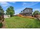 Backyard featuring a large yard, storage shed, and two-tiered wooden deck at 10859 W Fair Ave, Littleton, CO 80127