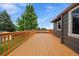 Backyard deck is built to the side of the home with a well-manicured lawn at 10859 W Fair Ave, Littleton, CO 80127