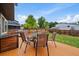Large backyard features a wood deck with outdoor dining furniture, perfect for entertaining at 10859 W Fair Ave, Littleton, CO 80127