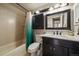 Standard bathroom featuring a shower-tub combo with vanity at 10859 W Fair Ave, Littleton, CO 80127