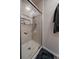 Bathroom featuring tiled shower with glass door at 10859 W Fair Ave, Littleton, CO 80127