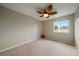 Neutral bedroom with large window and fan at 10859 W Fair Ave, Littleton, CO 80127