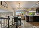 Stylish kitchen and dining area with black cabinets, granite countertops, and a large window with neighborhood views at 10859 W Fair Ave, Littleton, CO 80127