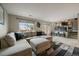 Spacious living area featuring a comfortable sectional and staircase at 10859 W Fair Ave, Littleton, CO 80127