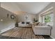Bright living room with neutral color palette, stylish decor, and a large window offering a pleasant view at 10859 W Fair Ave, Littleton, CO 80127