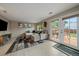 Comfortable living area with plush seating, neutral decor, and sliding doors leading to outdoor patio at 10859 W Fair Ave, Littleton, CO 80127