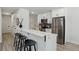 Modern kitchen with stainless steel appliances, white cabinetry, and a breakfast bar with stylish seating at 7970 Chase Cir # 85, Arvada, CO 80003