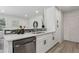 Open kitchen design features white cabinets, modern backsplash, and stainless steel appliances for a contemporary feel at 7970 Chase Cir # 85, Arvada, CO 80003