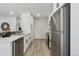 Bright and modern kitchen with stainless steel appliances, white cabinets, and ample counter space at 7970 Chase Cir # 85, Arvada, CO 80003