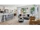Bright living room features a large window, grey sofa, stylish rug, and bar stool seating for entertaining at 7970 Chase Cir # 85, Arvada, CO 80003