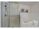 Bright bathroom with glass enclosed shower and tub with white tile surround at 6375 W 6Th Ave, Lakewood, CO 80214