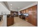 Kitchen with stainless appliances, granite counters, and tile floor and built-in desk at 6375 W 6Th Ave, Lakewood, CO 80214