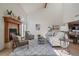 Sunlit living room with vaulted ceilings, hardwood floors, and a cozy fireplace at 6375 W 6Th Ave, Lakewood, CO 80214