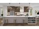 Bright, modern kitchen with a waterfall island, stylish pendant lighting, and stainless steel appliances at 2281 S Sherman St, Denver, CO 80210
