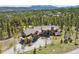 Aerial view of the property with mature trees, landscaped yard, and long driveway at 41 Barton Ridge Dr, Breckenridge, CO 80424