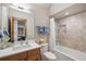 Clean bathroom featuring a shower and tub, modern vanity, and wood trim at 41 Barton Ridge Dr, Breckenridge, CO 80424