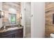 Stylish bathroom featuring wood plank accent wall, walk-in shower, marble countertop and modern fixtures at 41 Barton Ridge Dr, Breckenridge, CO 80424