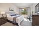 Bright bedroom featuring a large window with tree views, stylish decor, and a cozy carpet at 41 Barton Ridge Dr, Breckenridge, CO 80424