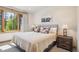 Inviting bedroom with a plaid headboard, rustic wood accents and tranquil view at 41 Barton Ridge Dr, Breckenridge, CO 80424