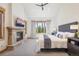 Bedroom with stone fireplace and large window showing an excellent forest view at 41 Barton Ridge Dr, Breckenridge, CO 80424
