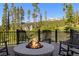 Deck featuring a stone fire pit with Adirondack chairs, perfect for enjoying outdoor views at 41 Barton Ridge Dr, Breckenridge, CO 80424