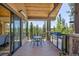 Relaxing deck with forest views, barbecue grill, and outdoor dining area at 41 Barton Ridge Dr, Breckenridge, CO 80424