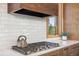 Elegant kitchen with custom wood cabinetry, white tile backsplash, and modern range at 41 Barton Ridge Dr, Breckenridge, CO 80424