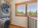 Convenient laundry room with stacked washer/dryer and a scenic window view at 41 Barton Ridge Dr, Breckenridge, CO 80424
