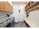 Spacious laundry room with modern washer and dryer, storage cabinets, and bench at 41 Barton Ridge Dr, Breckenridge, CO 80424